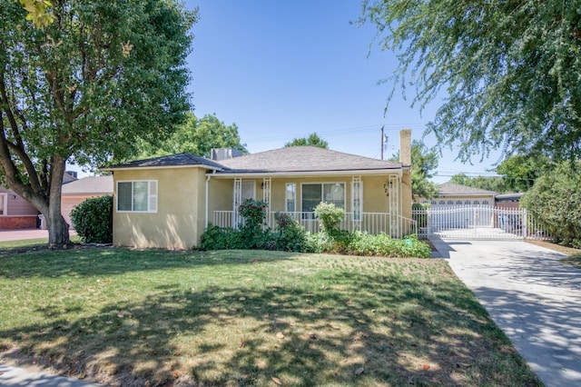 724 W Harvard Ave, Fresno, CA 93705 - view of front of home with stucco siding, covered porch, driveway, and a chimney