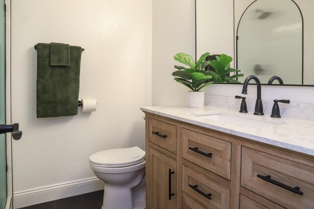 2881 E Huntington Blvd Unit 230, Fresno, CA 93721 - bathroom with vanity, toilet, baseboards, and tile patterned flooring