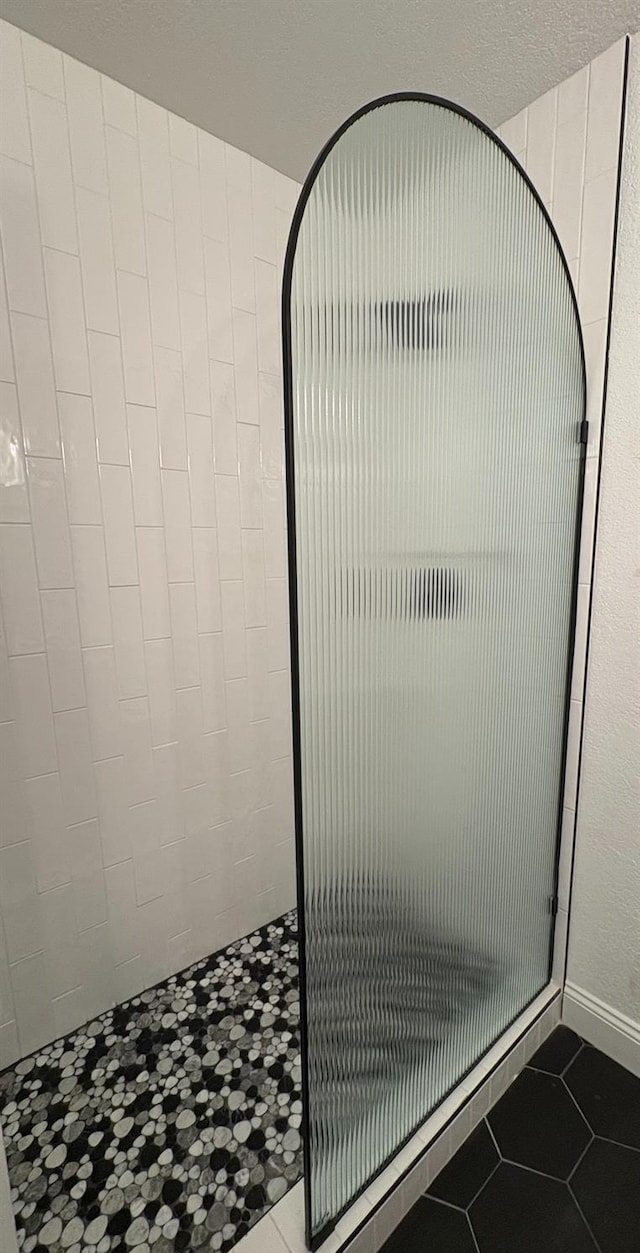 2881 E Huntington Blvd Unit 230, Fresno, CA 93721 - bathroom featuring a shower stall and tile patterned floors