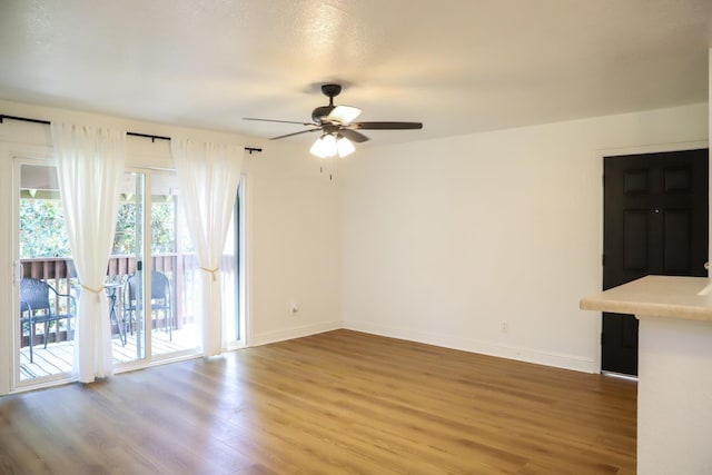 2881 E Huntington Blvd Unit 230, Fresno, CA 93721 - empty room featuring wood finished floors, ceiling fan, and baseboards