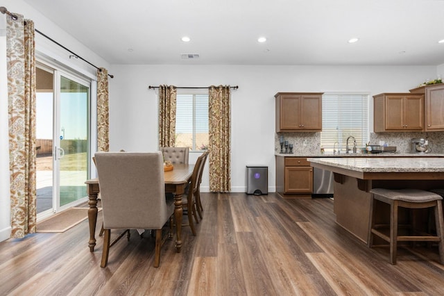 2027 N Bliss Ave, Fresno, CA 93727 - kitchen featuring dark wood-style flooring, plenty of natural light, tasteful backsplash, stainless steel dishwasher, and recessed lighting