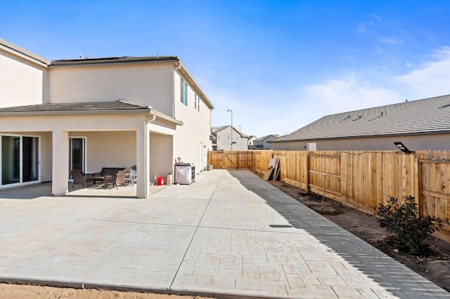 2027 N Bliss Ave, Fresno, CA 93727 - back of house featuring a fenced backyard, a patio, and stucco siding