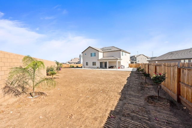 2027 N Bliss Ave, Fresno, CA 93727 - rear view of house with a fenced backyard, solar panels, and a patio area