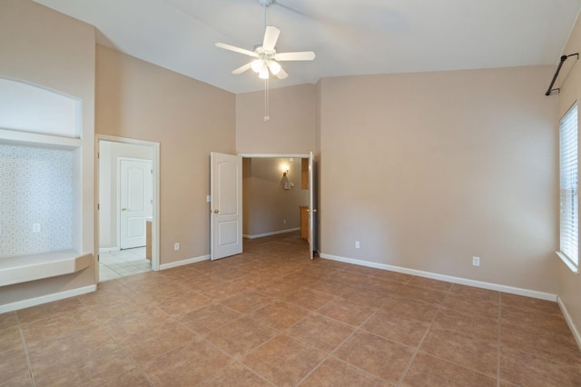 2841 E Brandon Ln, Fresno, CA 93720 - unfurnished bedroom featuring multiple windows, lofted ceiling, light tile patterned flooring, a ceiling fan, and ensuite bathroom