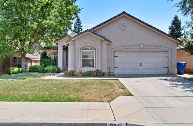 2841 E Brandon Ln, Fresno, CA 93720 - view of front of home featuring a garage, concrete driveway, stucco siding, and a front yard