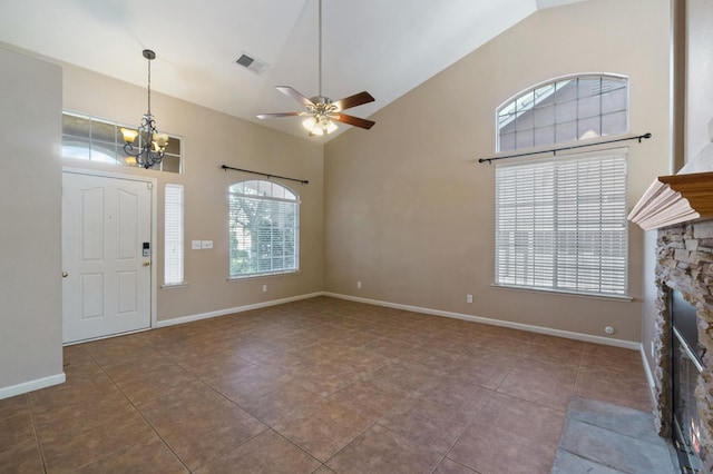 2841 E Brandon Ln, Fresno, CA 93720 - foyer entrance with a chandelier, a ceiling fan, high vaulted ceiling, tile patterned floors, and a stone fireplace
