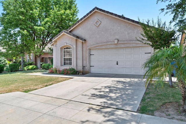 2841 E Brandon Ln, Fresno, CA 93720 - view of front of property with driveway, stucco siding, an attached garage, and a front yard