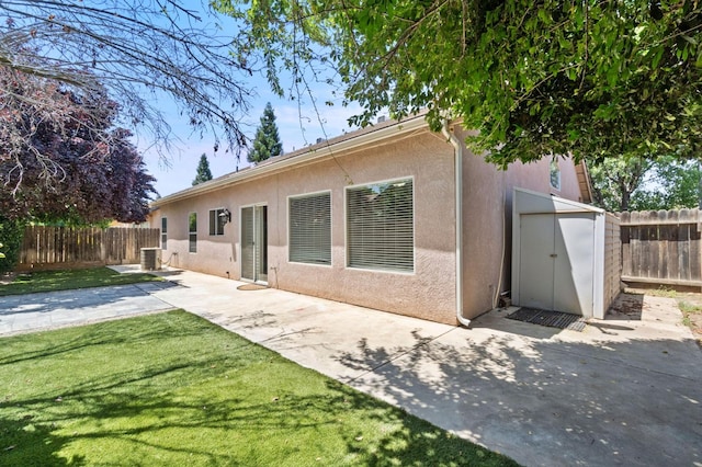 2841 E Brandon Ln, Fresno, CA 93720 - back of house featuring stucco siding, a fenced backyard, a patio, and a storage unit