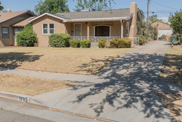 1702 N Adoline Ave, Fresno, CA 93705 - ranch-style house with a porch, stucco siding, and roof with shingles