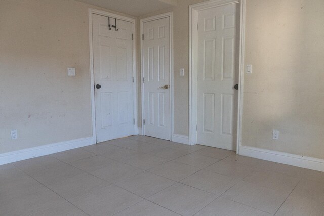 2048 N Arthur Ave, Fresno, CA 93705 - unfurnished bedroom with baseboards and tile patterned flooring