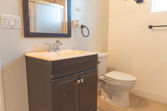 2048 N Arthur Ave, Fresno, CA 93705 - bathroom featuring toilet, vanity, tile patterned flooring, and baseboards