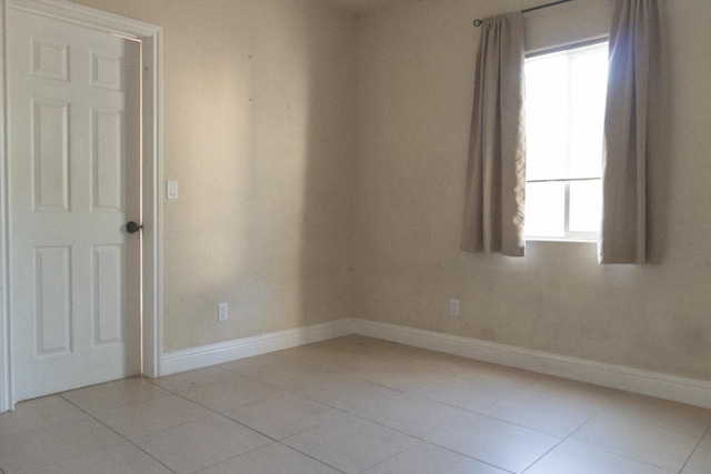 2048 N Arthur Ave, Fresno, CA 93705 - unfurnished room featuring baseboards, healthy amount of natural light, and light tile patterned flooring