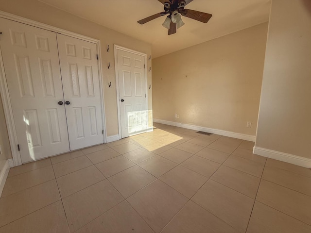 2048 N Arthur Ave, Fresno, CA 93705 - unfurnished bedroom with tile patterned flooring, baseboards, a closet, and a ceiling fan