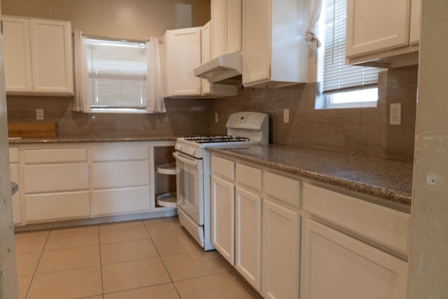 2048 N Arthur Ave, Fresno, CA 93705 - kitchen with gas range gas stove, under cabinet range hood, white cabinetry, backsplash, and light tile patterned flooring