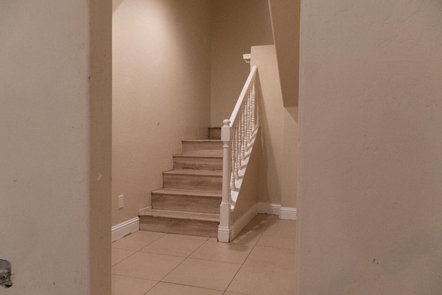 2048 N Arthur Ave, Fresno, CA 93705 - stairs featuring tile patterned floors and baseboards