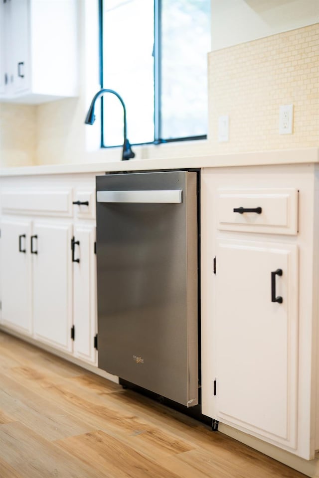 1707 Douglas Ave, Clovis, CA 93611 - kitchen with dishwasher, light wood finished floors, white cabinetry, and decorative backsplash