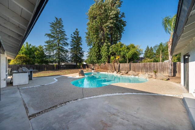 1707 Douglas Ave, Clovis, CA 93611 - view of pool featuring a patio area, grilling area, and a fenced backyard