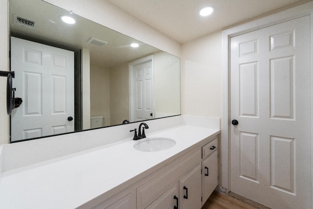 1707 Douglas Ave, Clovis, CA 93611 - bathroom featuring vanity, recessed lighting, and wood finished floors