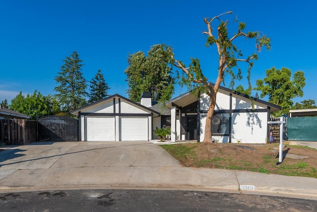 1707 Douglas Ave, Clovis, CA 93611 - view of front of property with an attached garage, concrete driveway, a gate, and stucco siding