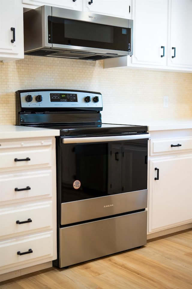 1707 Douglas Ave, Clovis, CA 93611 - kitchen with stainless steel appliances, light countertops, and white cabinets