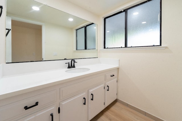 1707 Douglas Ave, Clovis, CA 93611 - bathroom featuring vanity, wood finished floors, baseboards, and recessed lighting