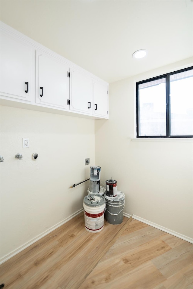 1707 Douglas Ave, Clovis, CA 93611 - washroom featuring cabinet space, electric dryer hookup, light wood-style floors, and baseboards