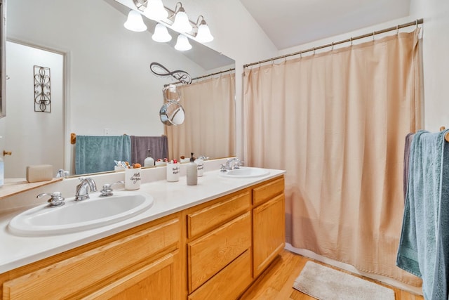 5572 W Indianapolis Ave, Fresno, CA 93722 - full bath featuring double vanity, wood finished floors, and curtained shower