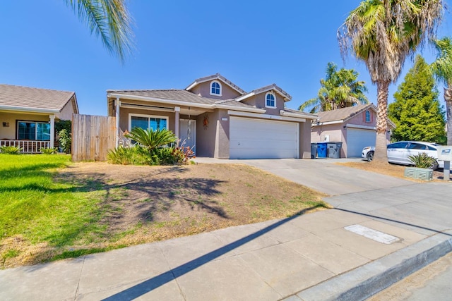 5572 W Indianapolis Ave, Fresno, CA 93722 - traditional home featuring stucco siding, an attached garage, concrete driveway, and a tiled roof