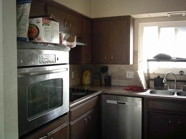 582 N Academy Ave, Sanger, CA 93657 - kitchen featuring stainless steel appliances, a sink, backsplash, and dark brown cabinetry