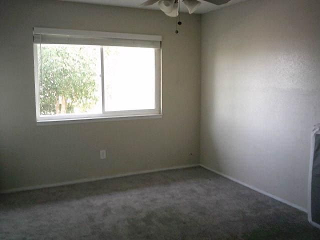 582 N Academy Ave, Sanger, CA 93657 - carpeted spare room with a ceiling fan and baseboards