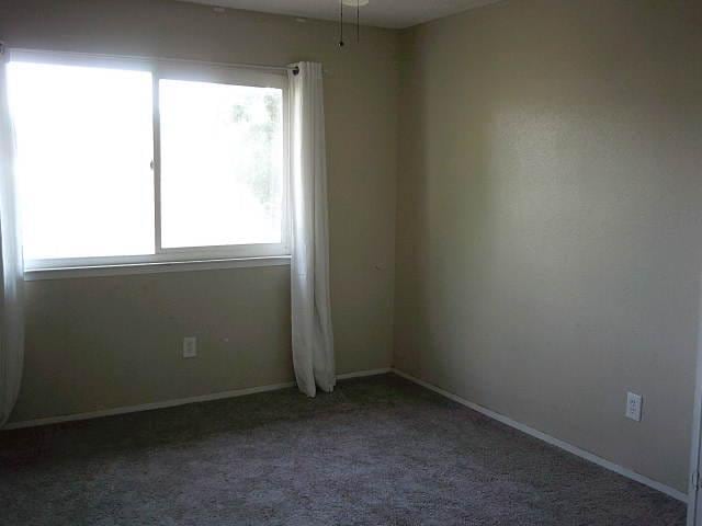 582 N Academy Ave, Sanger, CA 93657 - unfurnished room featuring plenty of natural light, carpet, and baseboards