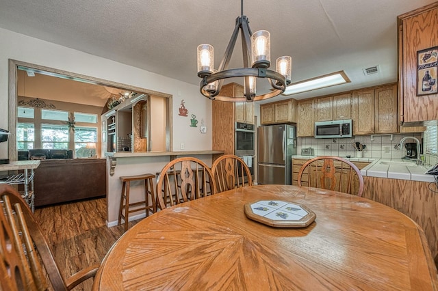 41228 Heartwood Ln, Shaver Lake, CA 93664 - dining room with a chandelier and wood finished floors