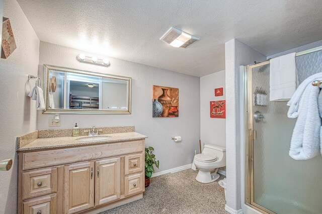 41228 Heartwood Ln, Shaver Lake, CA 93664 - full bath with vanity, a stall shower, toilet, a textured ceiling, and baseboards