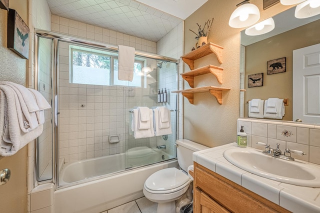 41228 Heartwood Ln, Shaver Lake, CA 93664 - bathroom with vanity, combined bath / shower with glass door, toilet, and tile patterned floors