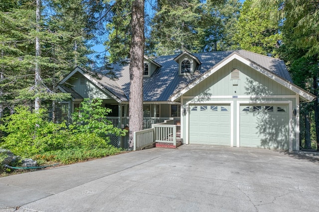 41228 Heartwood Ln, Shaver Lake, CA 93664 - view of front of property featuring driveway, an attached garage, metal roof, and a porch