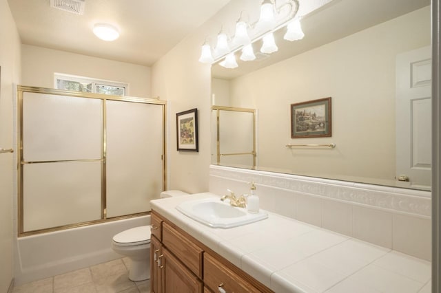 41035 Cold Springs Ln, Shaver Lake, CA 93664 - bathroom with vanity, toilet, bath / shower combo with glass door, and tile patterned floors