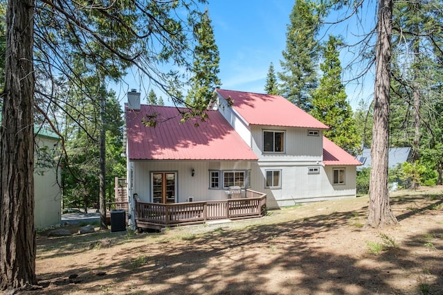 41035 Cold Springs Ln, Shaver Lake, CA 93664 - rear view of property featuring a chimney, a wooden deck, metal roof, and central AC
