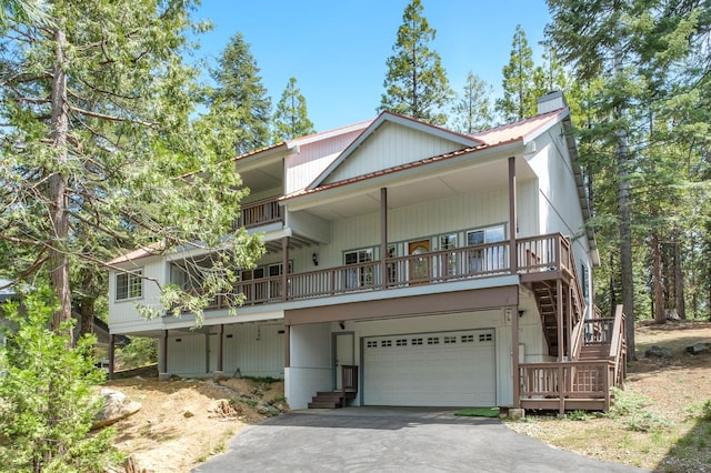 41035 Cold Springs Ln, Shaver Lake, CA 93664 - view of front of property with driveway, a garage, metal roof, and stairway