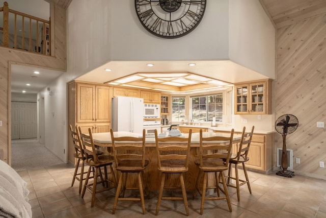 41035 Cold Springs Ln, Shaver Lake, CA 93664 - dining room featuring wood walls, a towering ceiling, recessed lighting, baseboards, and light tile patterned floors