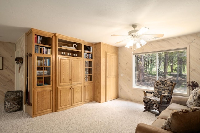 41035 Cold Springs Ln, Shaver Lake, CA 93664 - carpeted living room with wooden walls and a ceiling fan