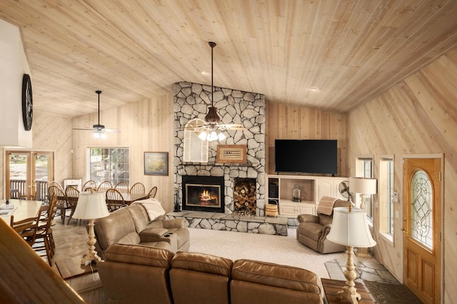 41035 Cold Springs Ln, Shaver Lake, CA 93664 - living room featuring wood ceiling, lofted ceiling, ceiling fan, wooden walls, and a stone fireplace