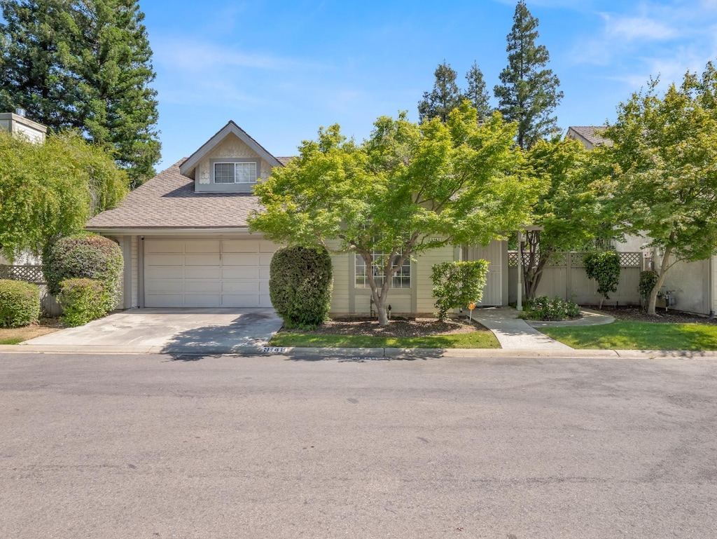 9146 N Stoneridge Ln, Fresno, CA 93720 - view of property hidden behind natural elements featuring driveway and a garage