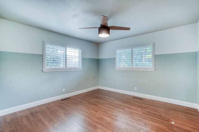 1463 W San Madele Ave, Fresno, CA 93711 - spare room with plenty of natural light, ceiling fan, wood finished floors, and baseboards