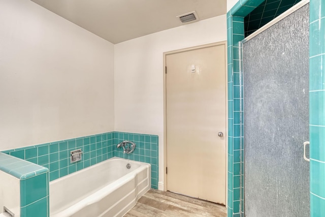1463 W San Madele Ave, Fresno, CA 93711 - full bath with wood finished floors, a bath, a shower stall, and tile walls