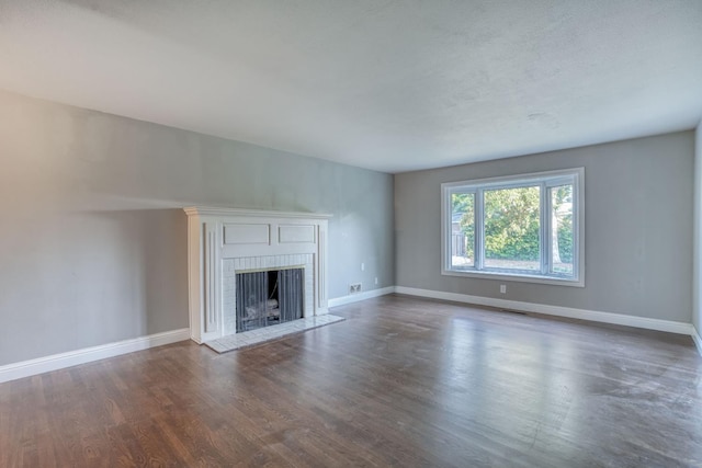 1463 W San Madele Ave, Fresno, CA 93711 - unfurnished living room featuring a fireplace, baseboards, and wood finished floors