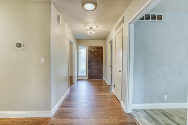 1463 W San Madele Ave, Fresno, CA 93711 - hallway featuring light wood finished floors, baseboards, and a textured ceiling
