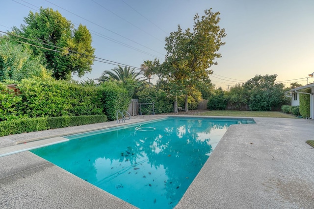 1463 W San Madele Ave, Fresno, CA 93711 - pool at dusk featuring a fenced backyard, a diving board, and a patio area