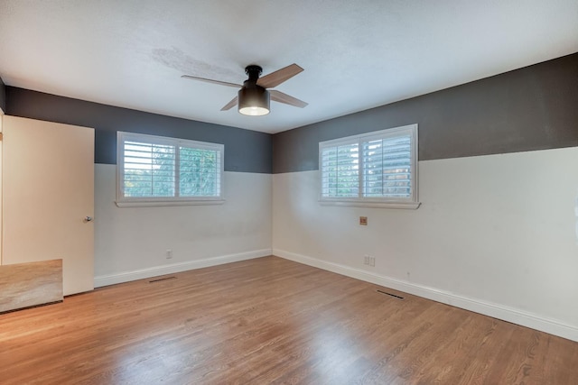 1463 W San Madele Ave, Fresno, CA 93711 - empty room featuring plenty of natural light, ceiling fan, and wood finished floors