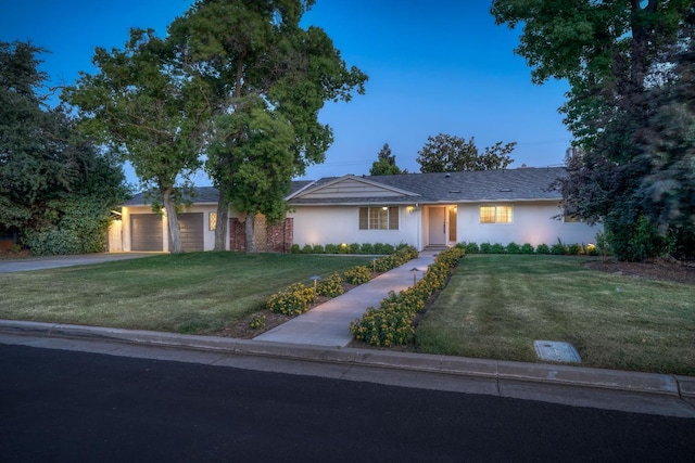 1463 W San Madele Ave, Fresno, CA 93711 - ranch-style home featuring a front yard, a garage, stucco siding, and driveway