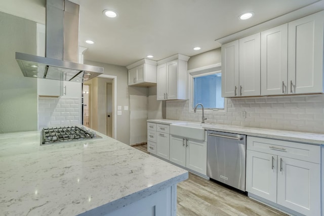 1463 W San Madele Ave, Fresno, CA 93711 - kitchen featuring stainless steel appliances, island exhaust hood, a sink, tasteful backsplash, and light wood-style flooring